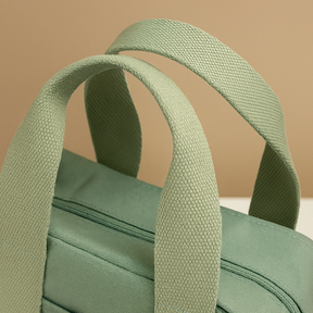 Stylish women’s canvas shoulder bag with adjustable strap, secure zipper, and multiple compartments for everyday essentials